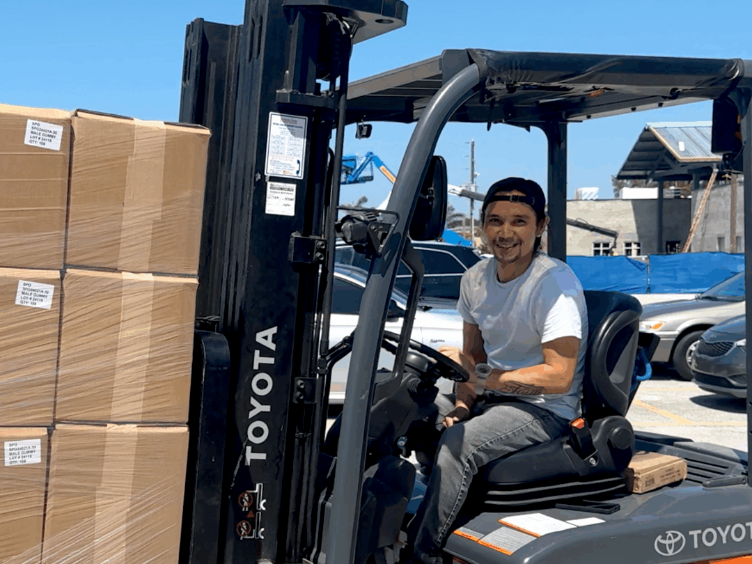 HBM team member operating a forklift to move packaged products outside the facility