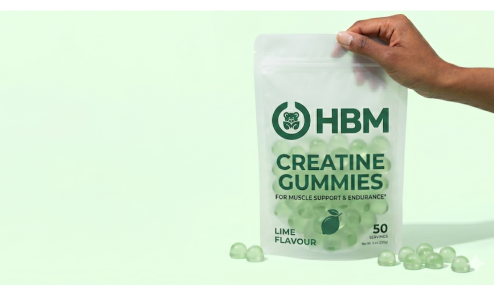 On the right, a person's hand holds a frosted semi-transparent stand-up pouch featuring the dark green HBM logo. The pouch is filled with clear, light green dome-shaped gummies and labeled "CREATINE GUMMIES" and "LIME FLAVOUR" indicating fast nutraceutical launches